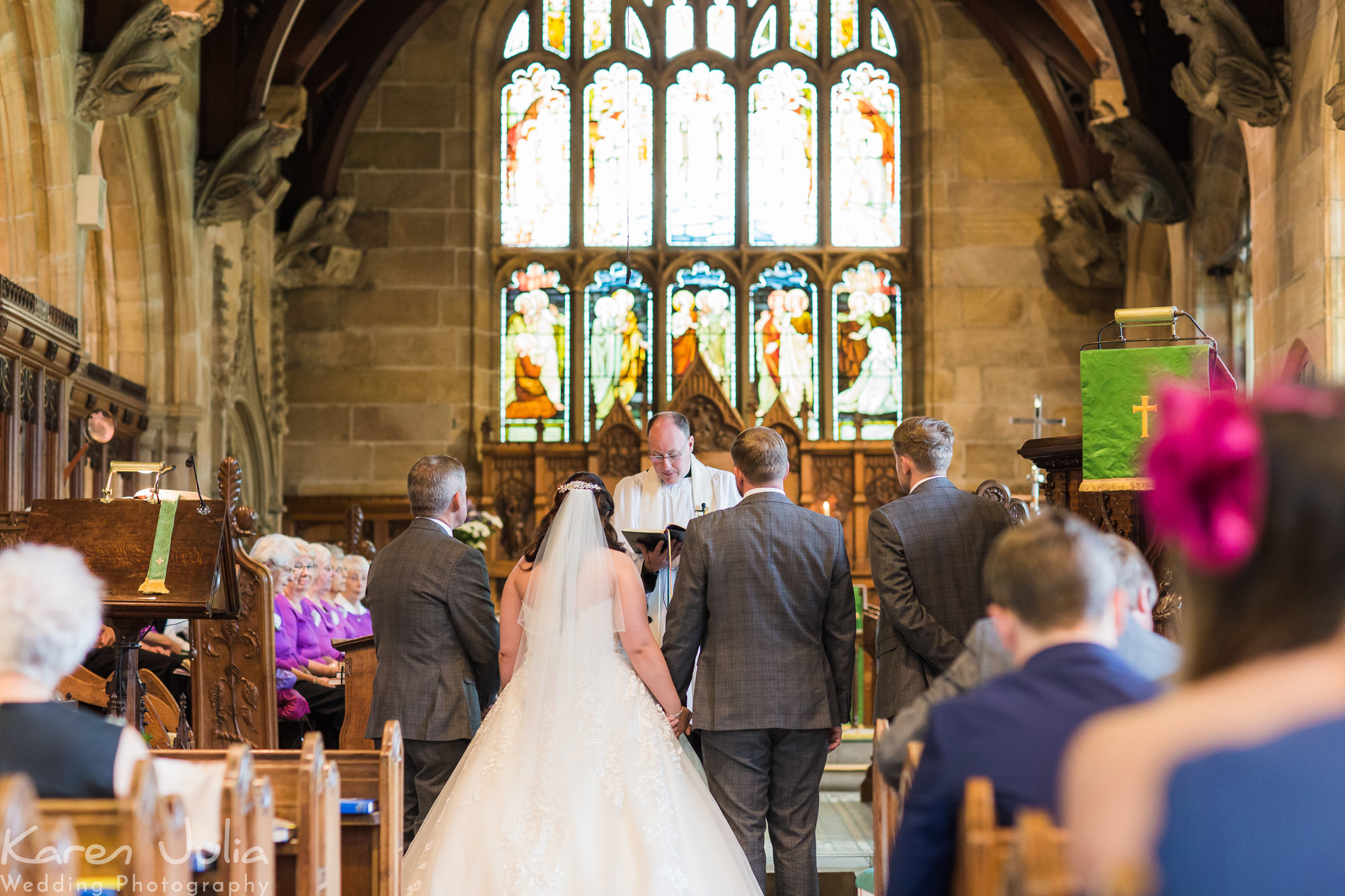 bride and groom exchange vows in St Michaels church, Aughton