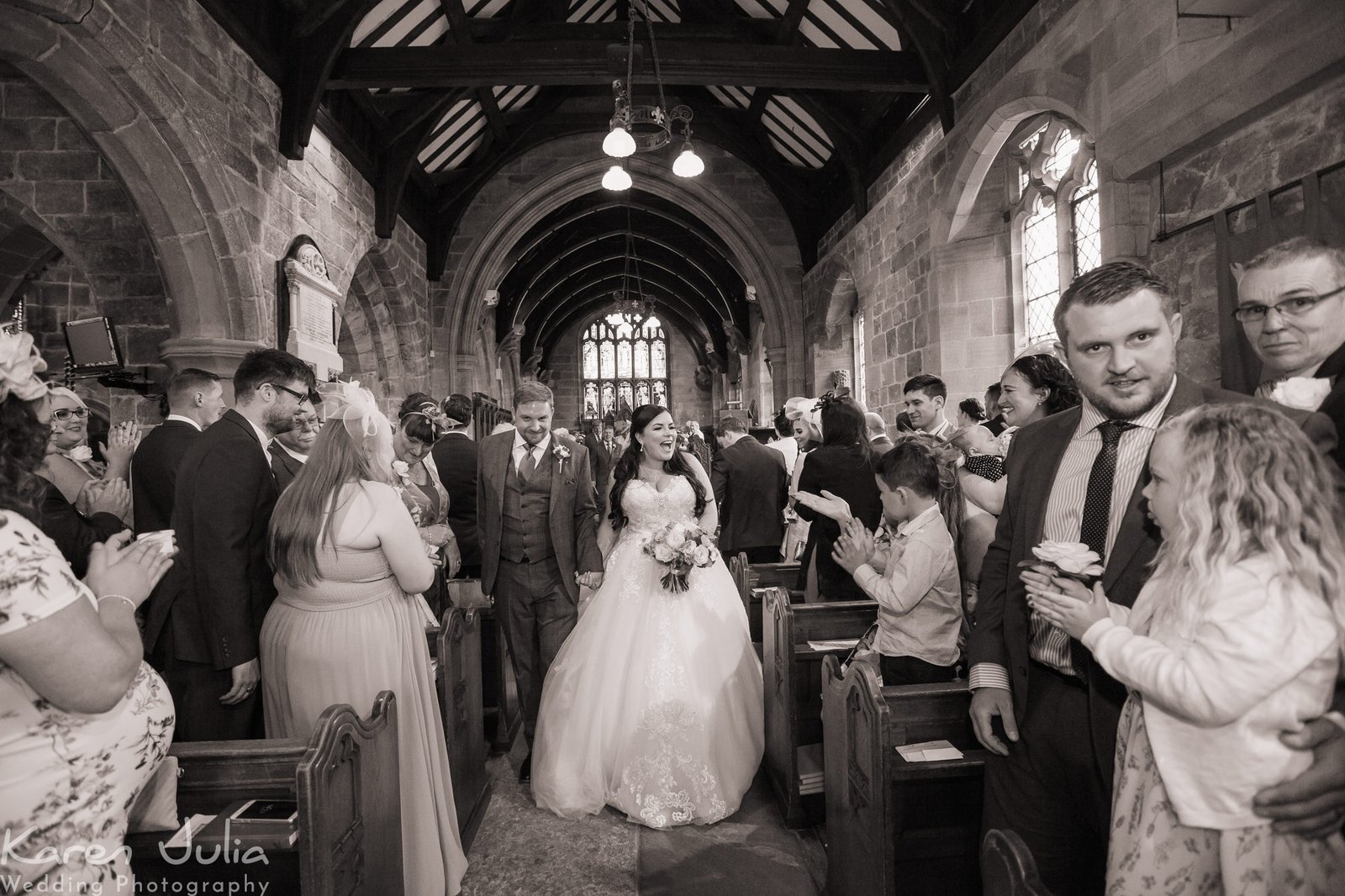 bride and groom walk up aisle together after wedding ceremony