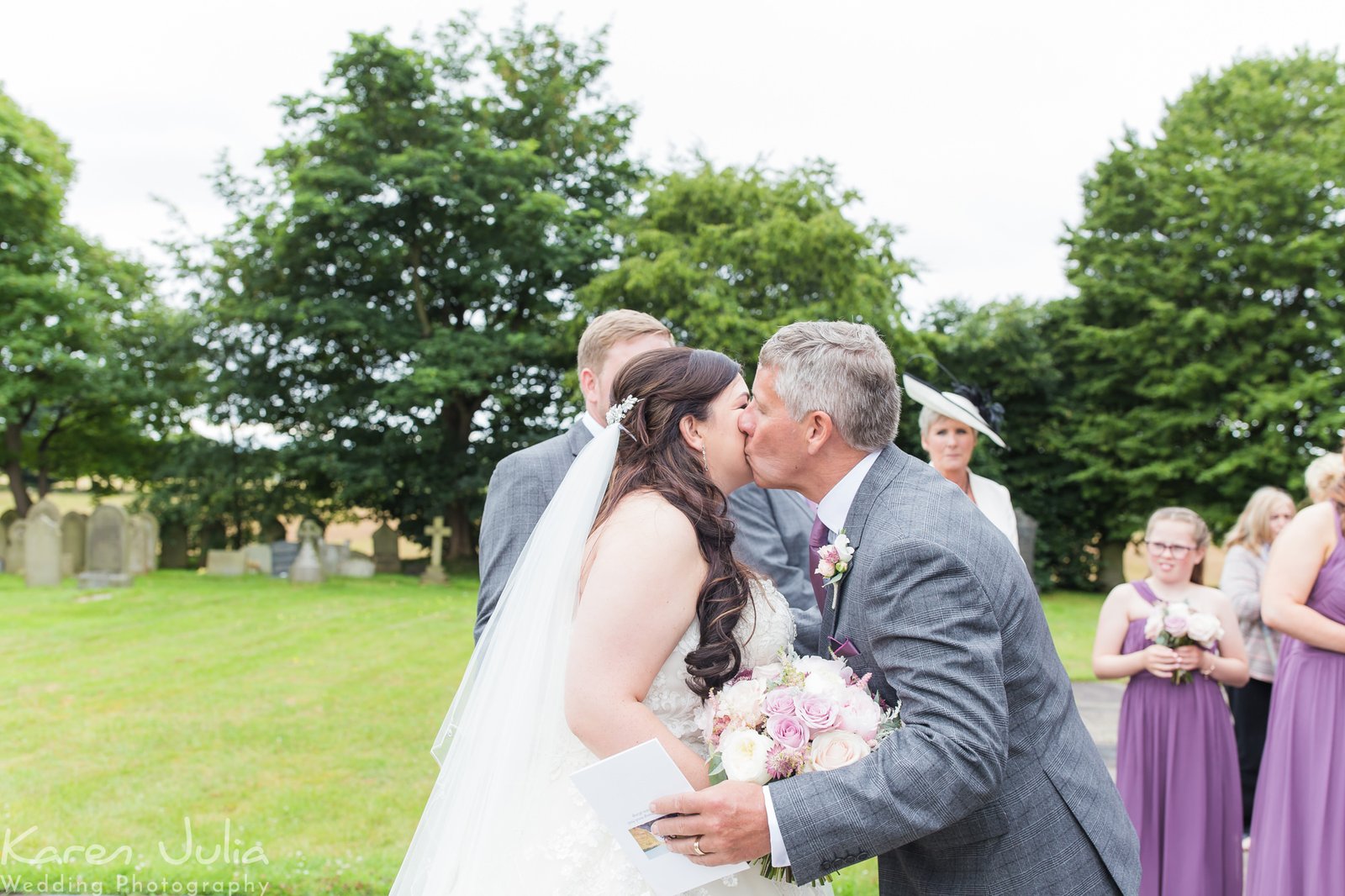 hugs and congratulations with bride and groom outside church