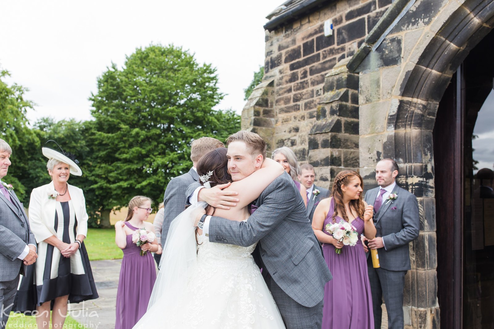 bride and groom greet guests outside church after the wedding ceremony