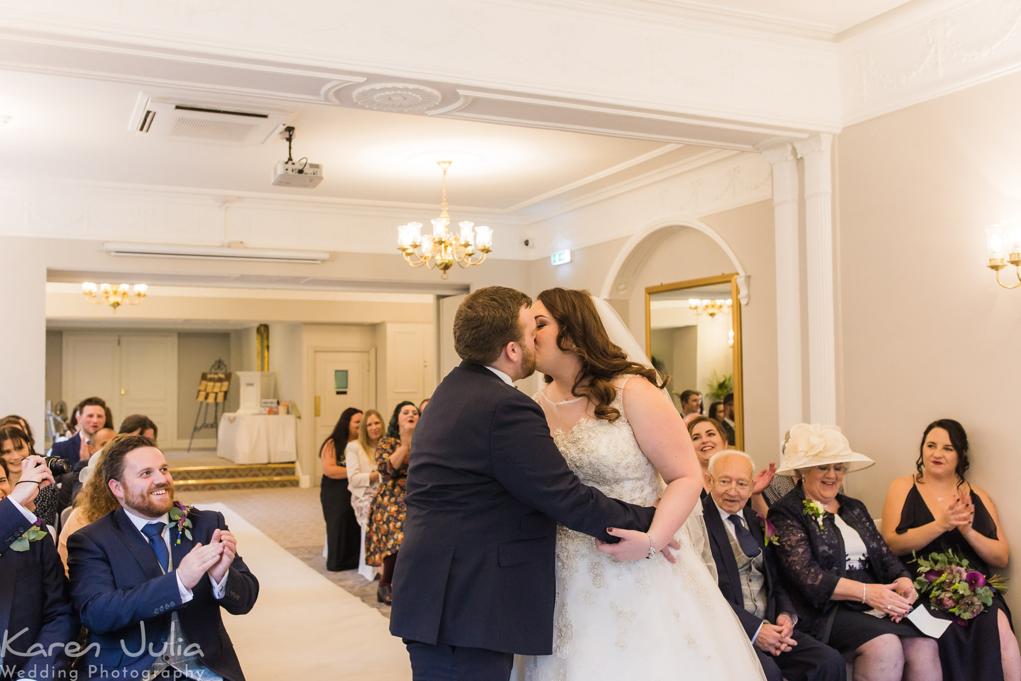 bride and groom kiss at the end of their wedding ceremony in Statham Lodge hotel