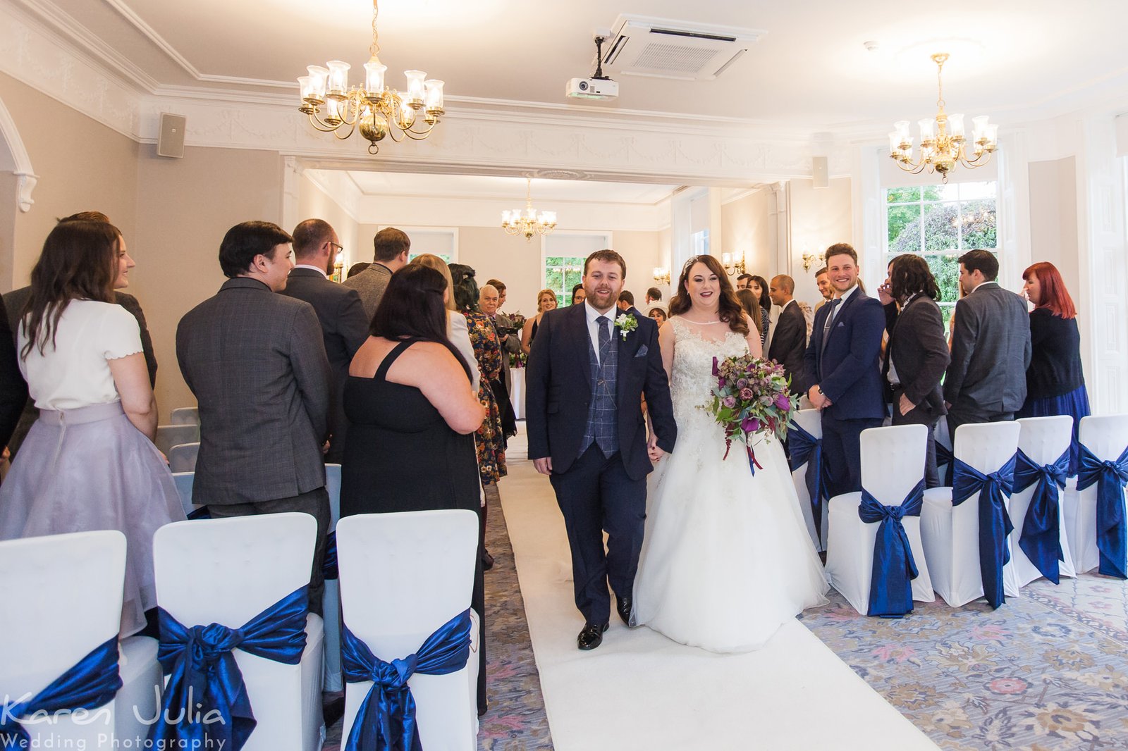 bride and groom walk up aisle together after their wedding ceremony