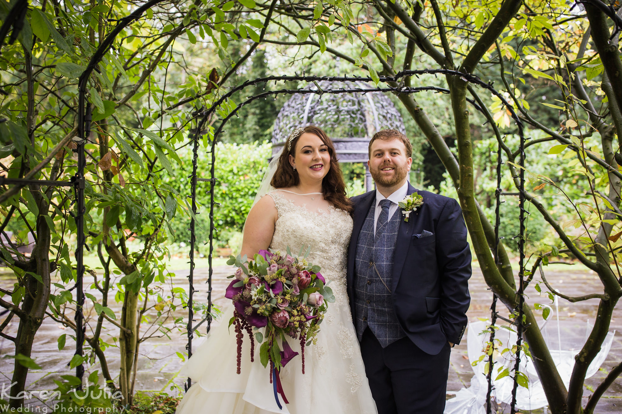 couple portraits under cover in the rain at statham Lodge hotel