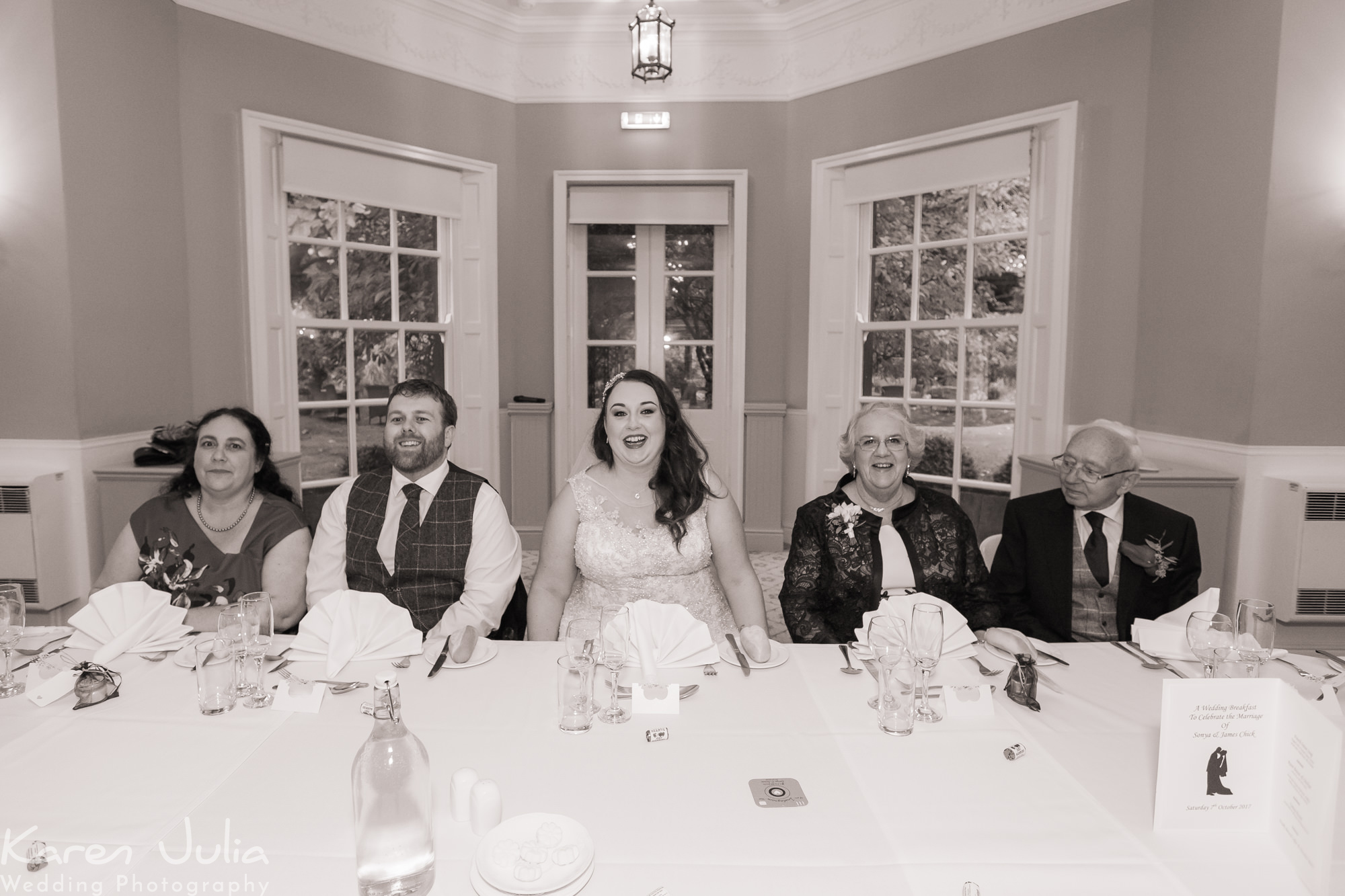 couple and their guests during wedding speeches