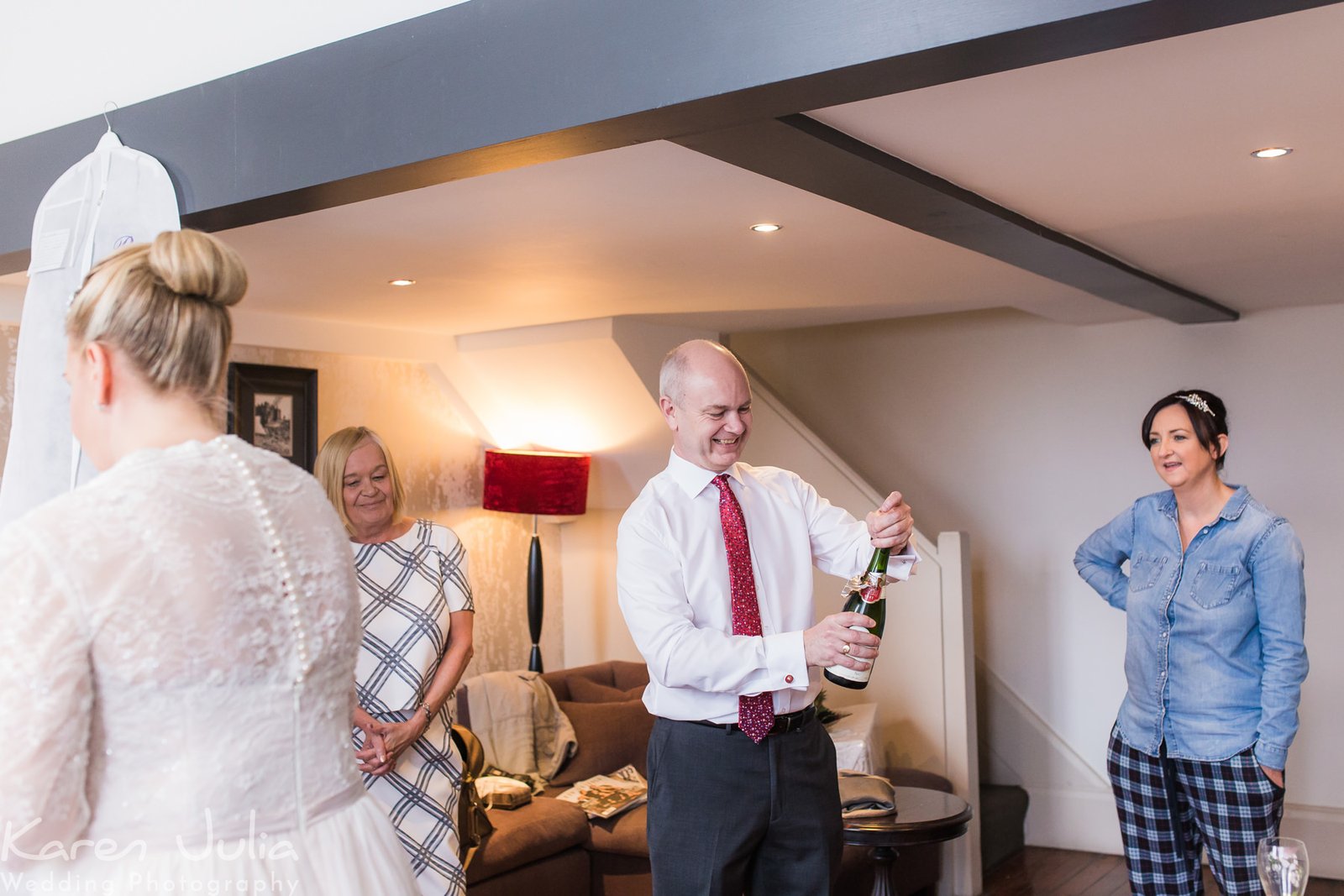 guest pouring champagne during bridal preparations