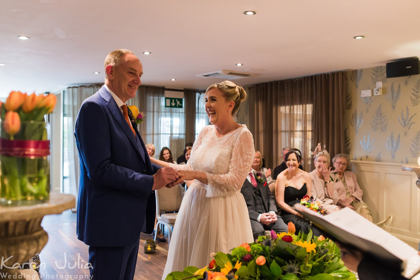 bride and groom exchange rings during wedding ceremony at Great John Street Hotel