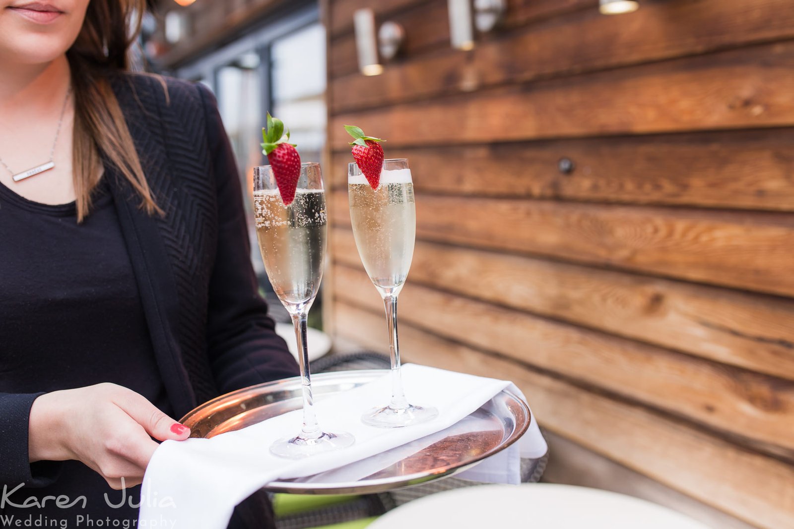 venue staff wait with champagne for the newly married couple