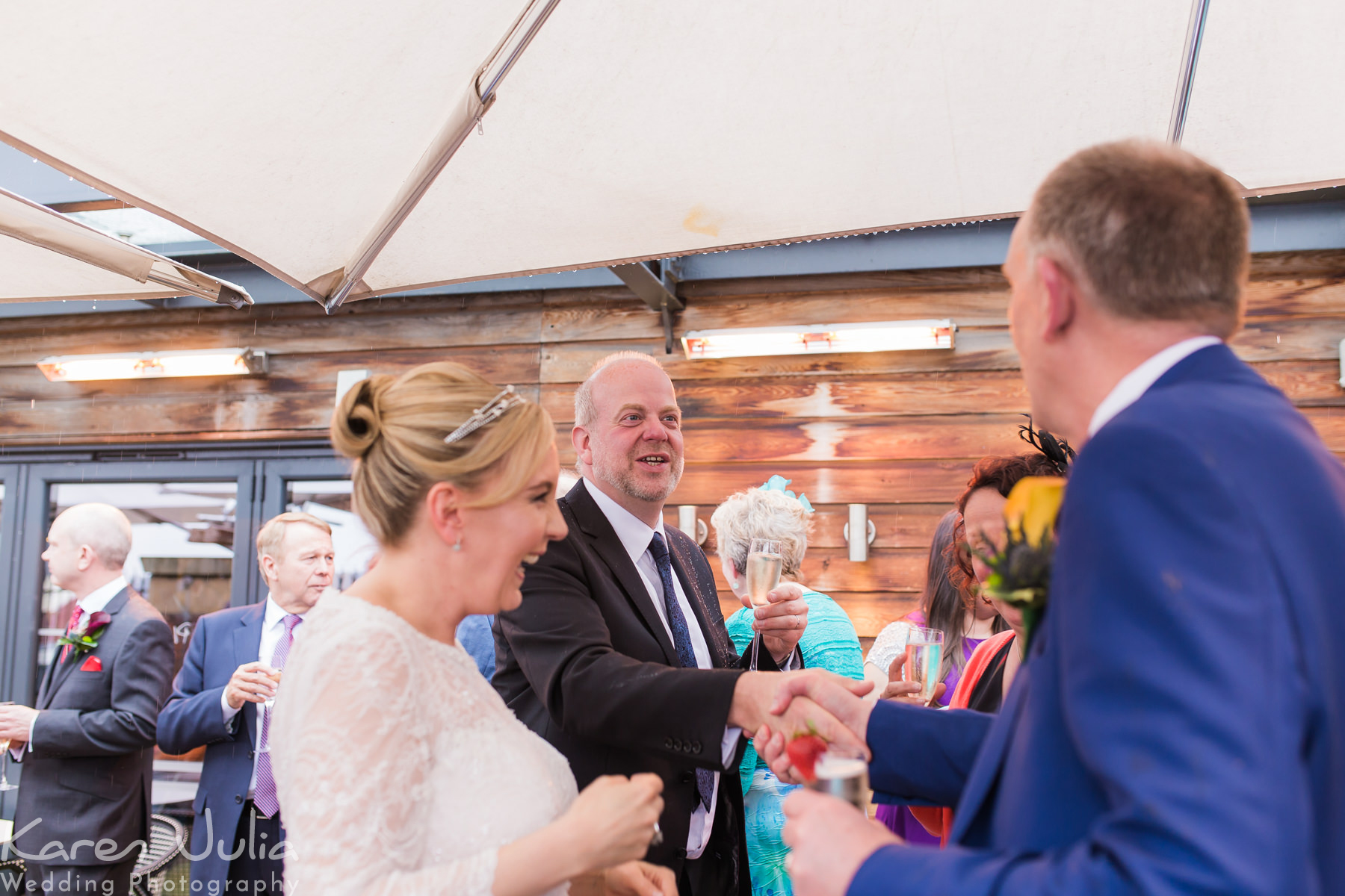 bride and groom mingle with guests during their drinks reception on the roof terrace