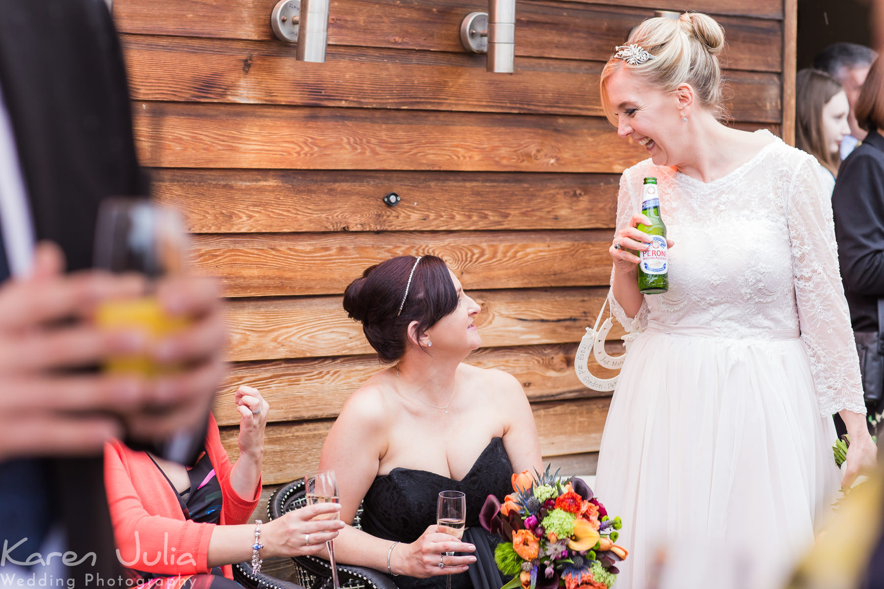 bride chats with bridesmaid on the roof terrace during the drinks reception
