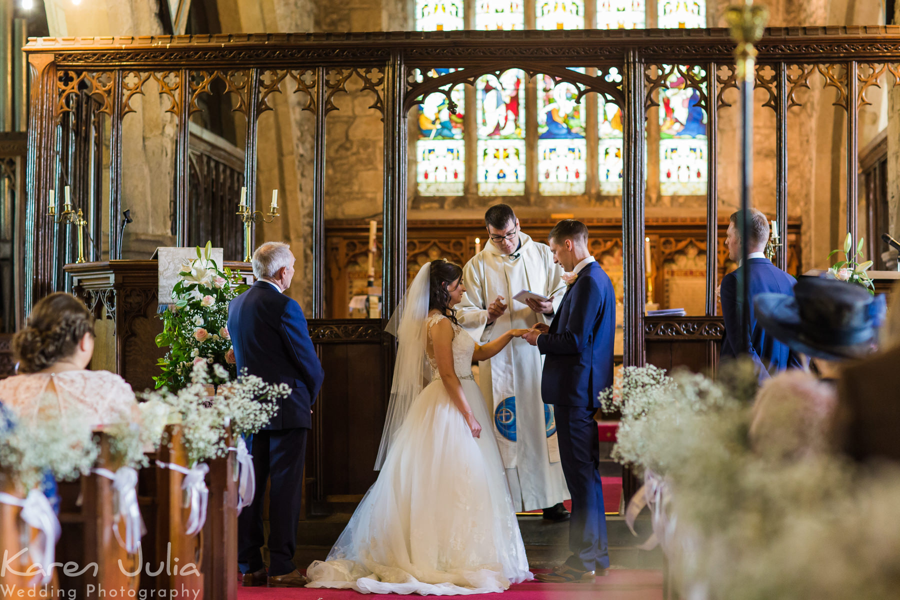 bride and groom exchange rings during wedding ceremony at St Mary the Virgins church in Long Preston