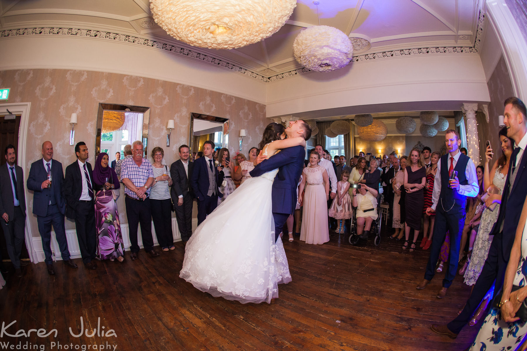 groom spins his bride on the dancefloor at Falcon Manor