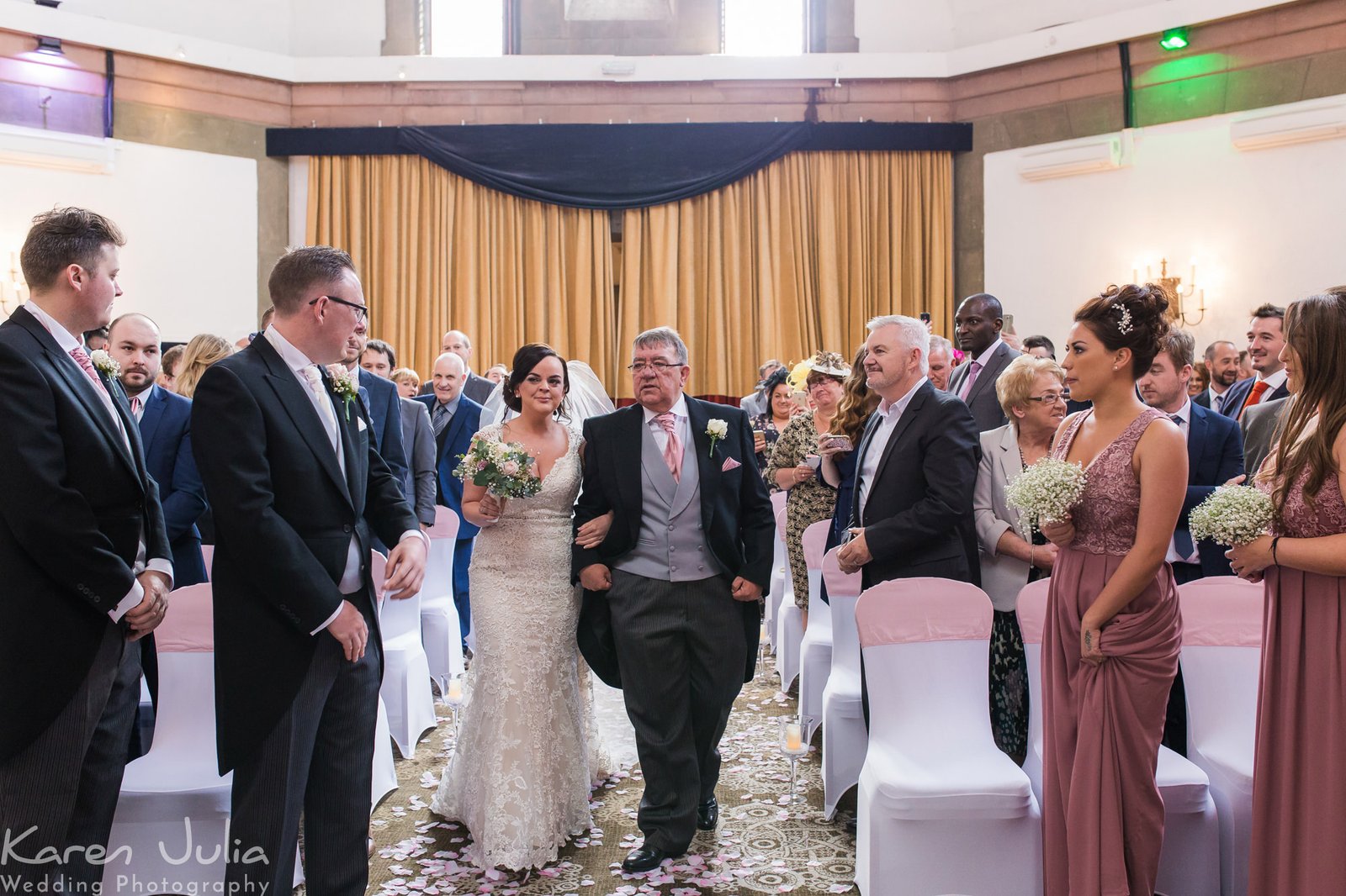 bride walks down aisle with her dad in the Tilden suite