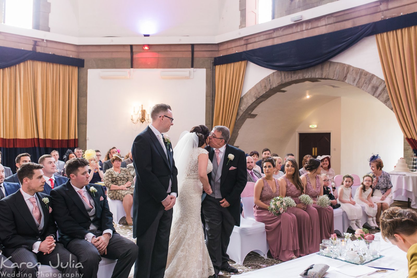 bride kisses dad before wedding ceremony