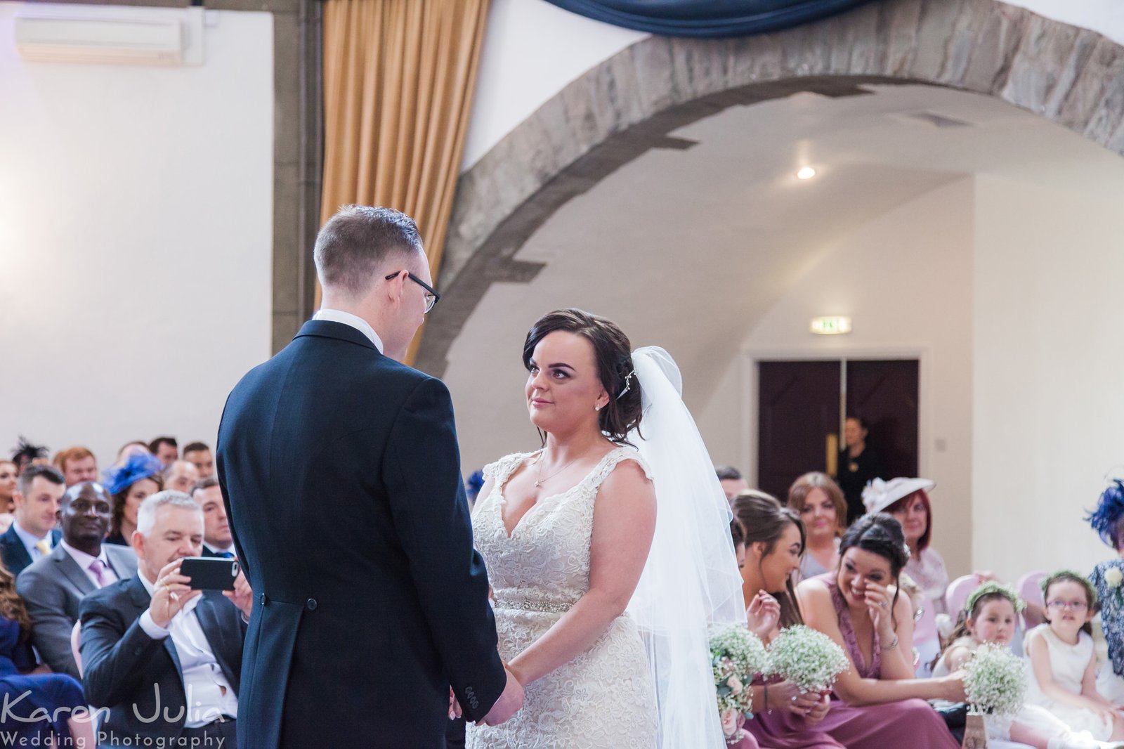 bride and groom exchange vows in the Tilden suite in Shrigley Hall