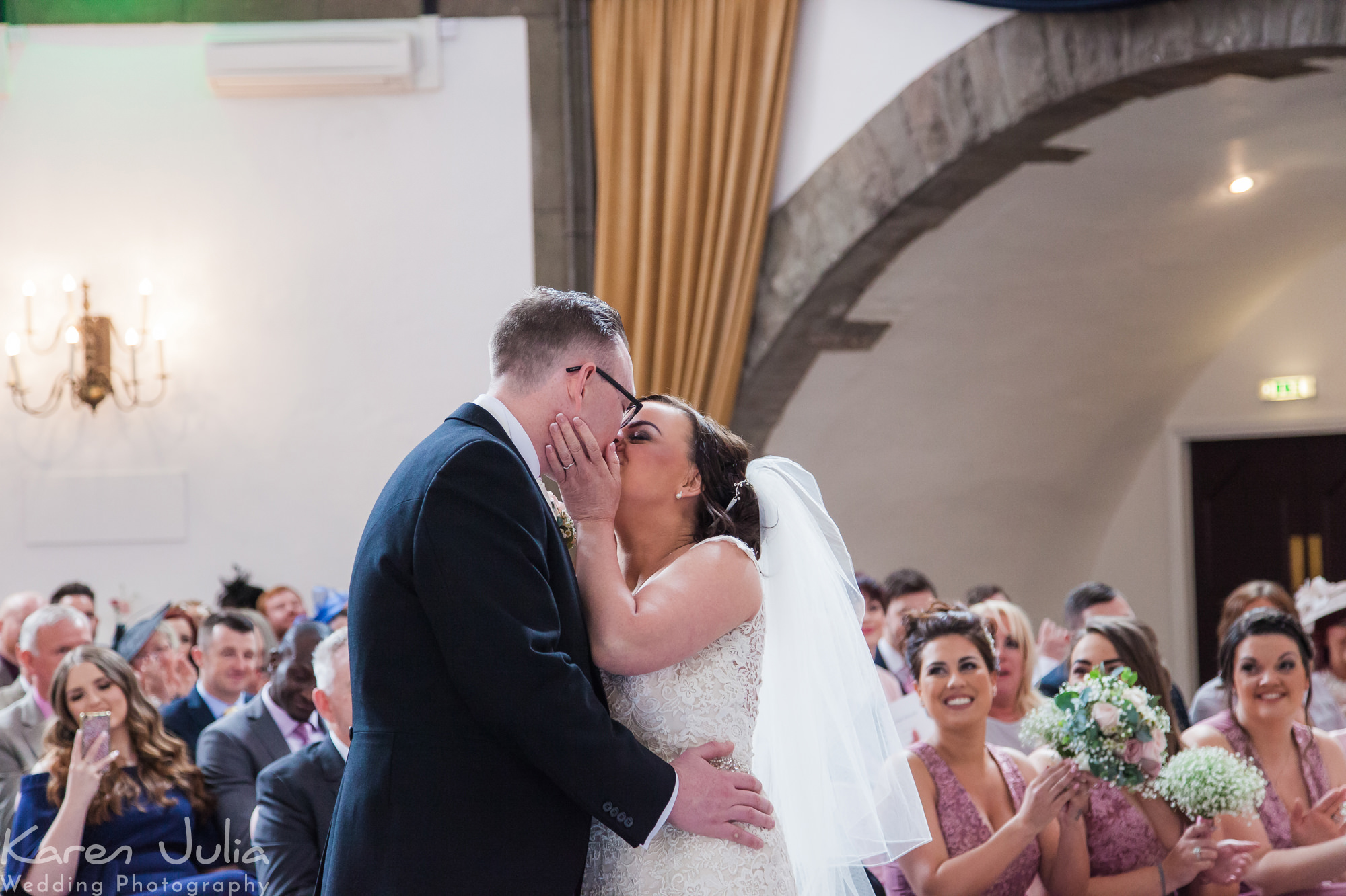 bride and groom kiss at the end of their wedding ceremony in Shrigley Hall