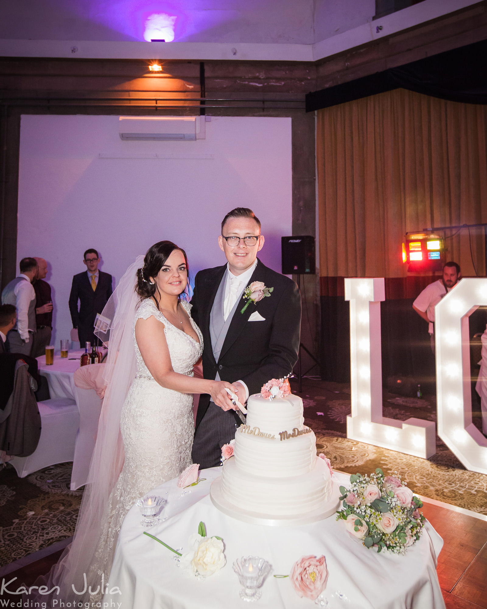 bride and groom cut the cake in the Tilden suite at their Springtime Shrigley Hall Wedding