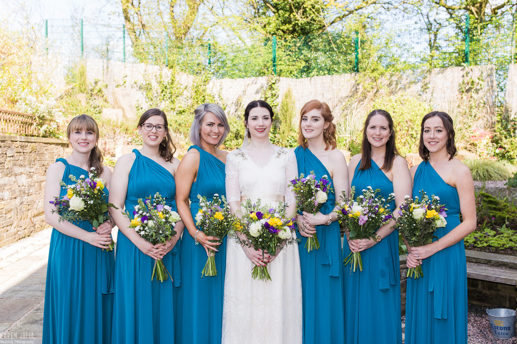 bridesmaids wearing teal coloured dresses