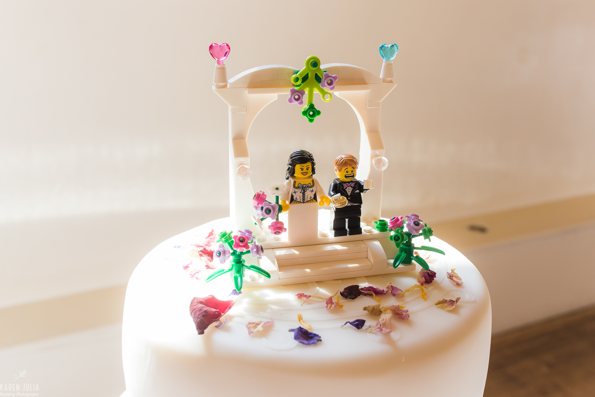 wedding cake featuring Lego bride and groom