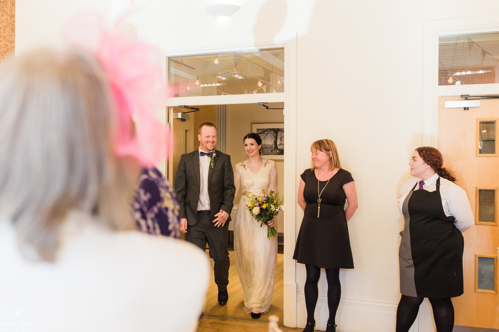 bride and groom enter wedding breakfast room