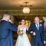 bride walks down aisle to meet groom at their Rustic Shireburn Arms Wedding