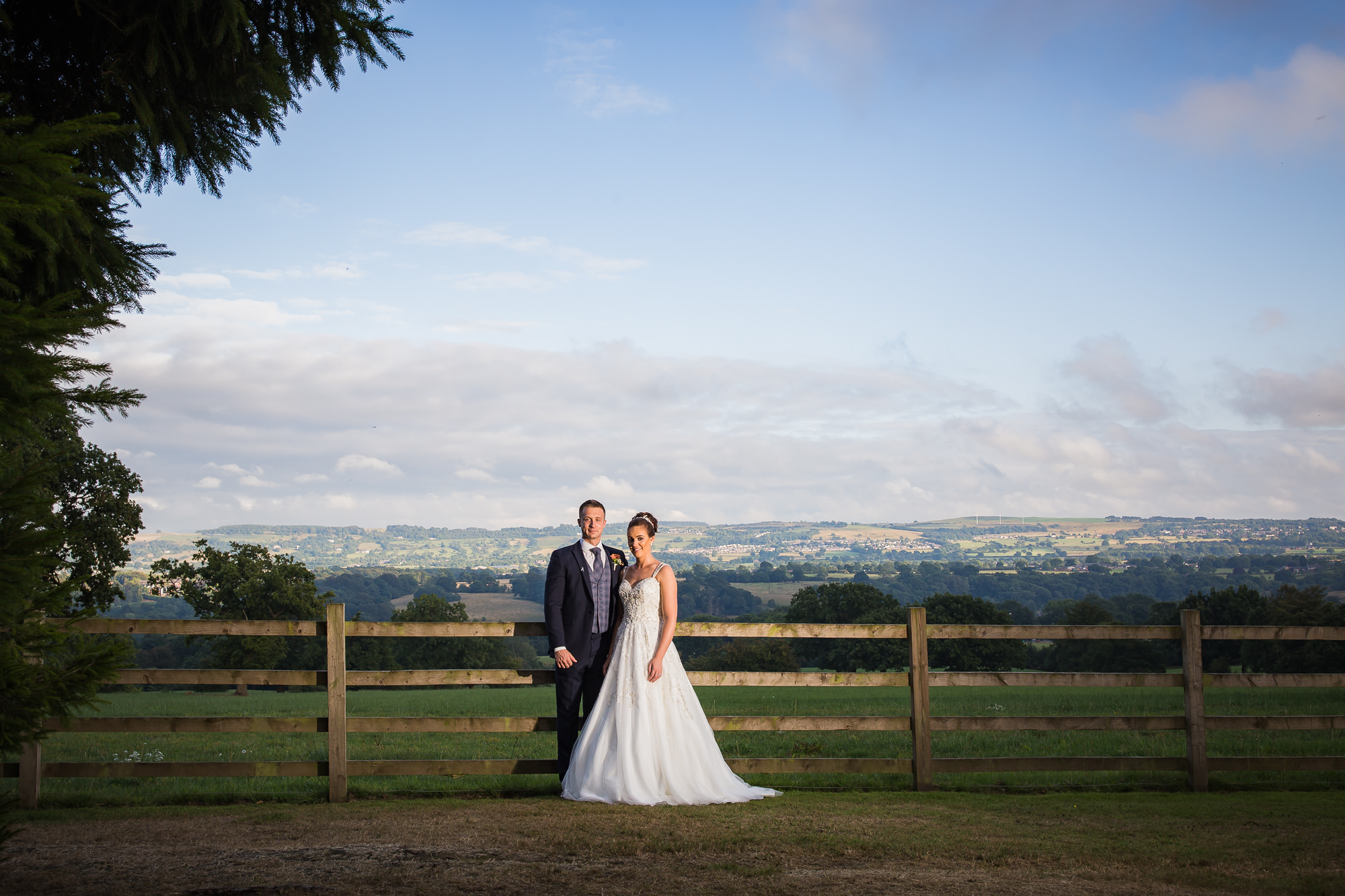 bride and groom portrait showing scenic views of the valley and hills at their Rustic Shireburn Arms Wedding