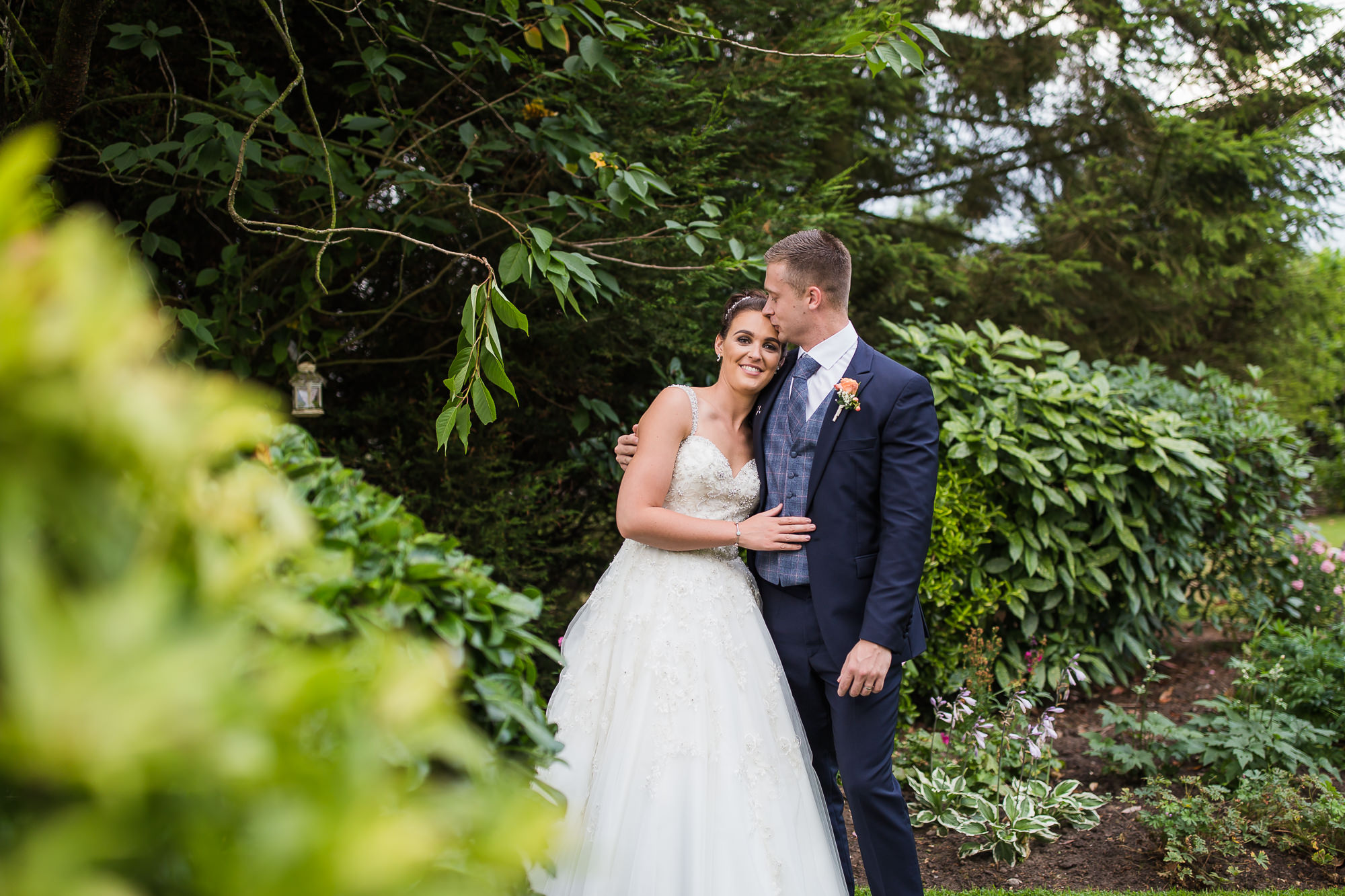 bride and groom portrait in the gardens after the rain at Shireburn Arms