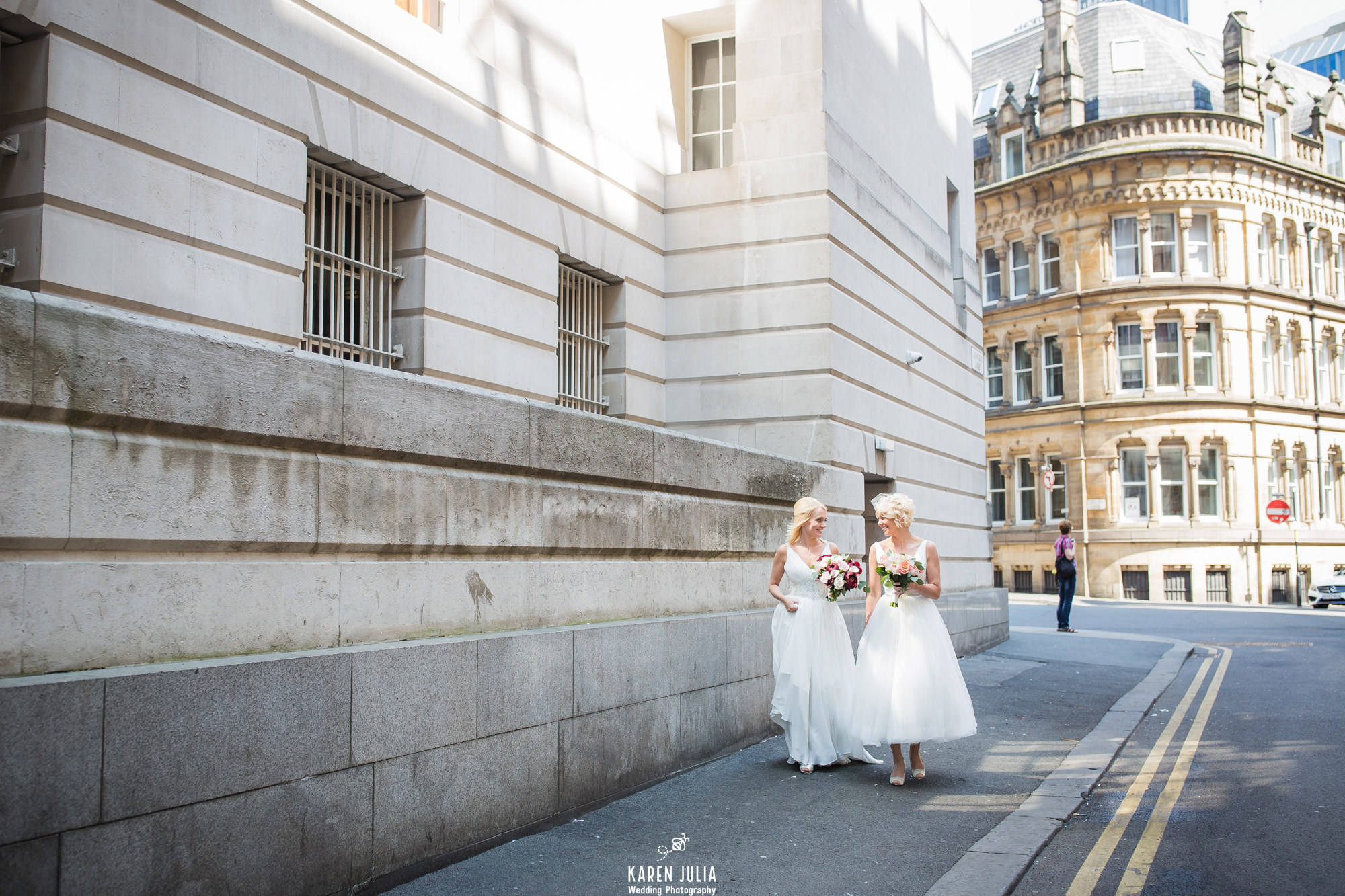 two brides walking together on their wedding day near King Street Townhouse