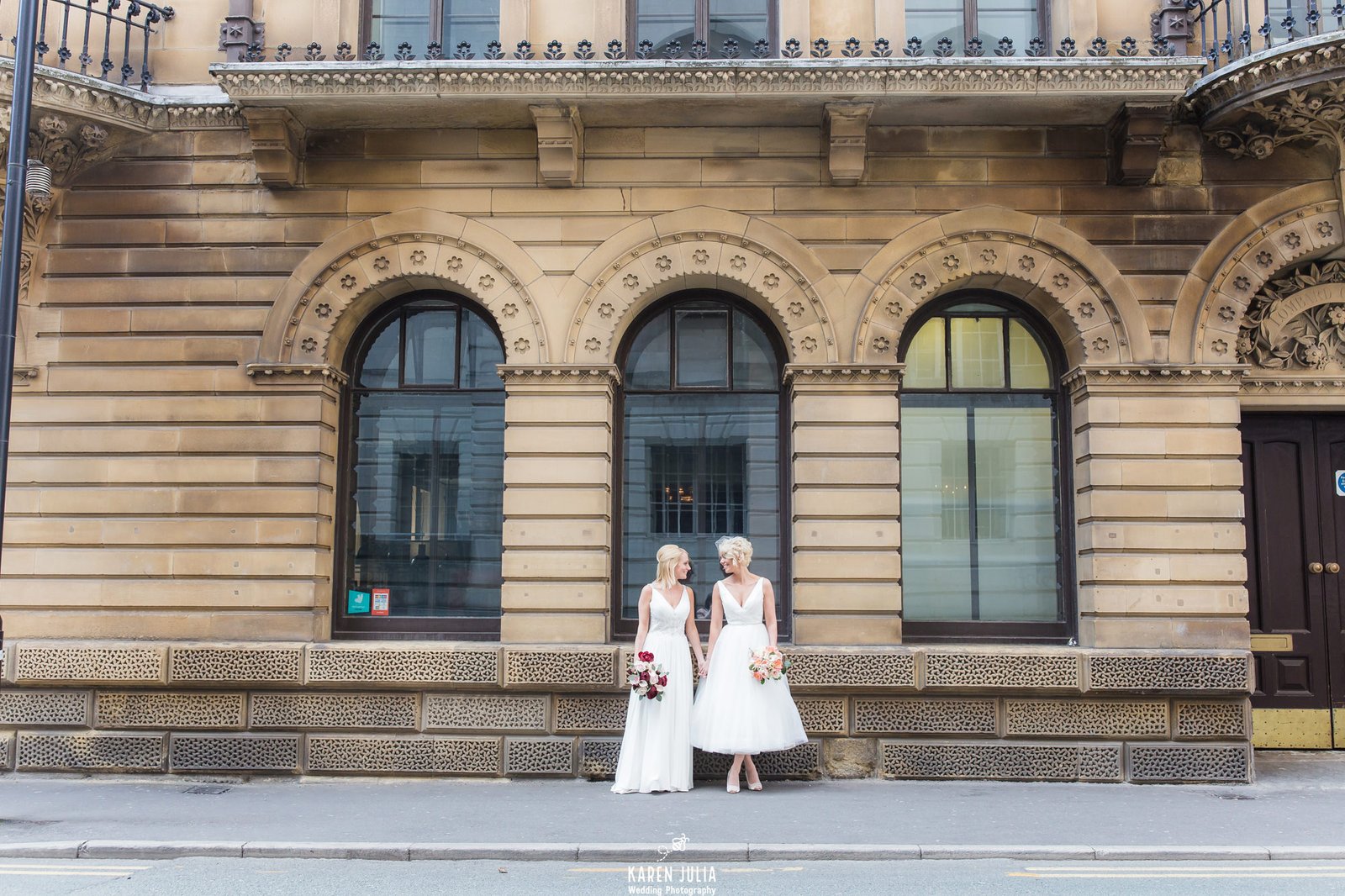 brides standing talking during wedding portraits near King Street Townhouse