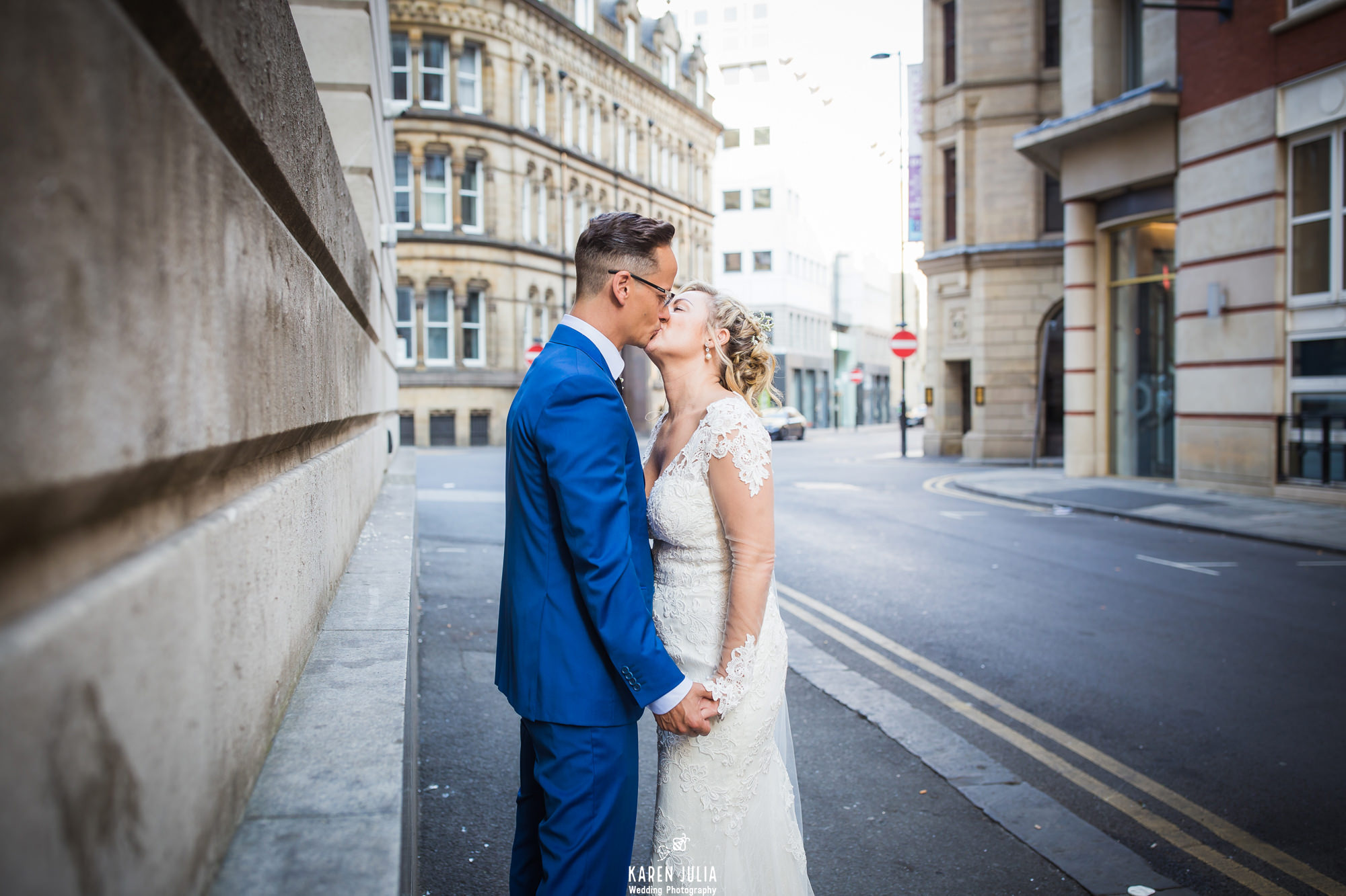 bride and groom kiss during their couple portrait shoot in Manchester city centre