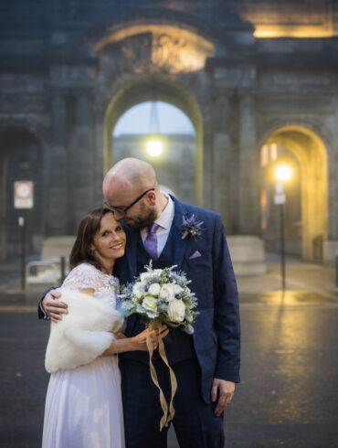 bride and groom pose for a wedding portrait outside Glasgow City Chambers