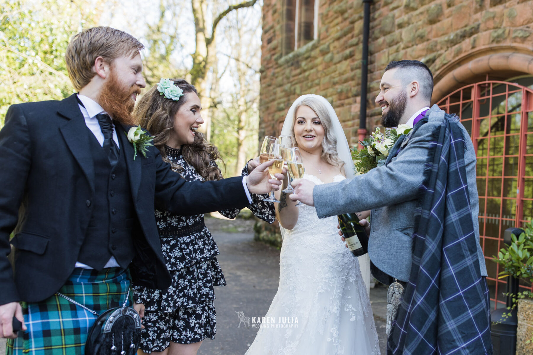 wedding couple and guests enjoy champagne celebration after the wedding ceremony at Pollockshields Burgh Hall