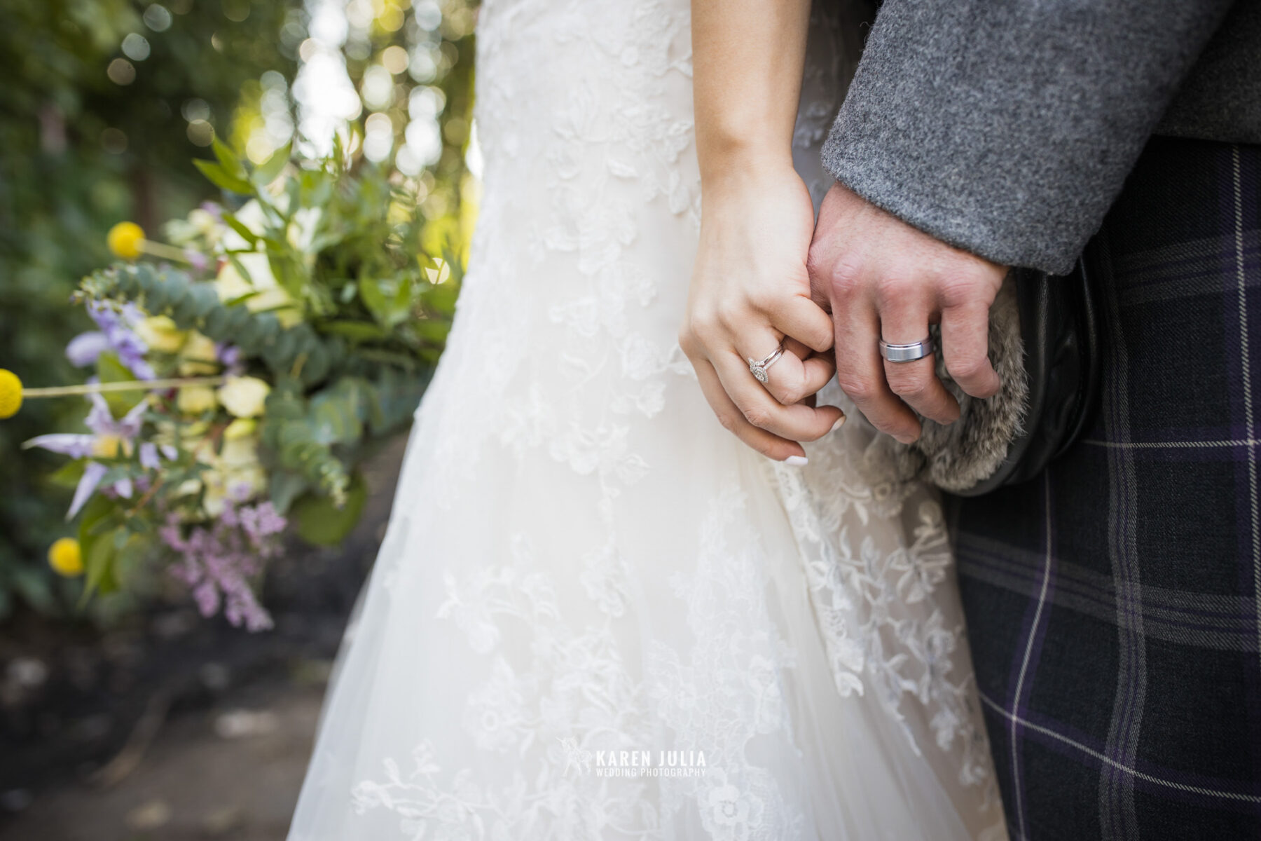 detail photo of bride and groom wearing their new wedding rings