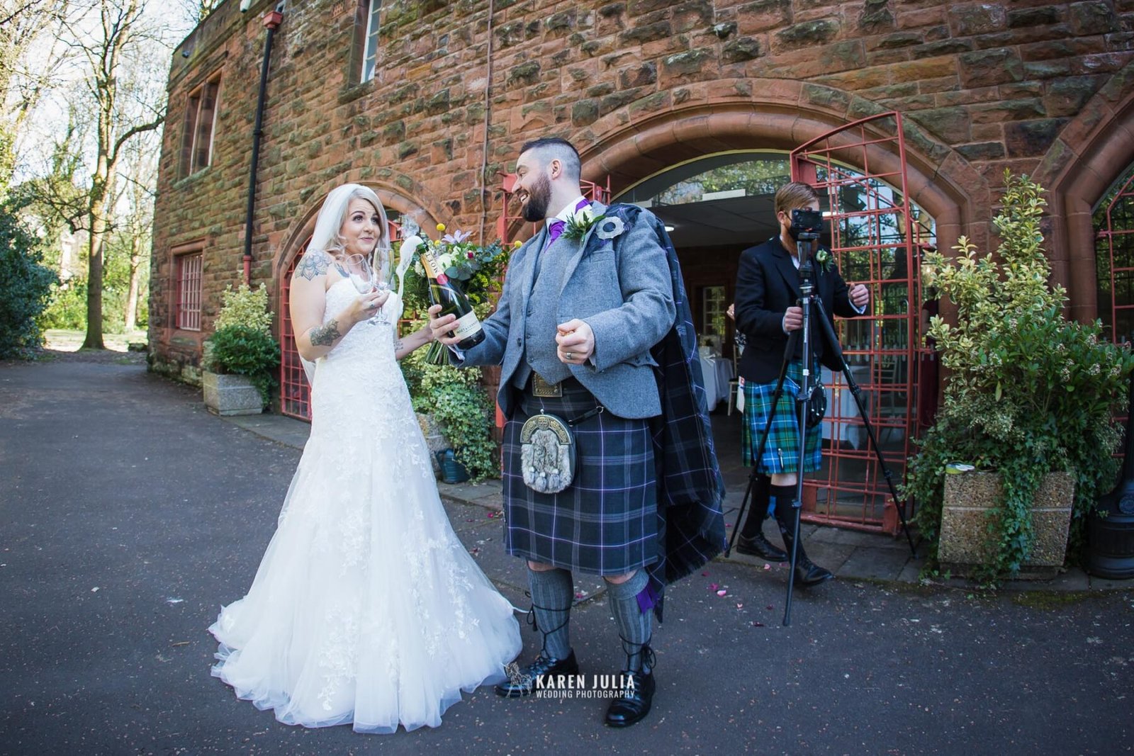 champagne spraying moment with bride and groom outside Pollockshields Burgh Hall