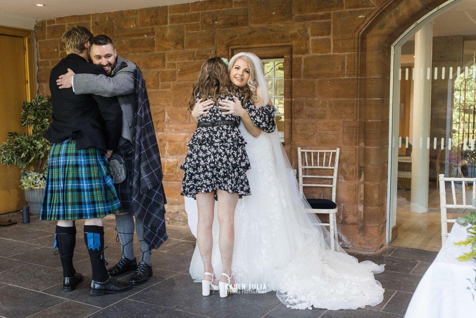 witnesses hug couple following their wedding ceremony at Pollokshields Burgh Hall 