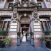 bride and groom portrait outside The Corinthian Club on their wedding day