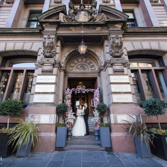 bride and groom portrait outside The Corinthian Club on their wedding day