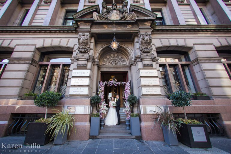 bride and groom portrait outside The Corinthian Club on their wedding day