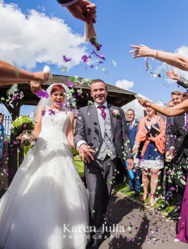 guests throw confetti at a sunny summer wedding