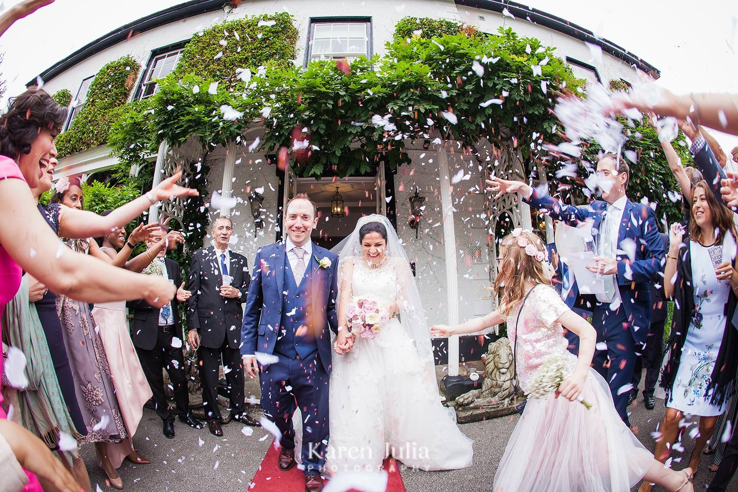 mix of dried flower and paper wedding confetti being thrown by guests