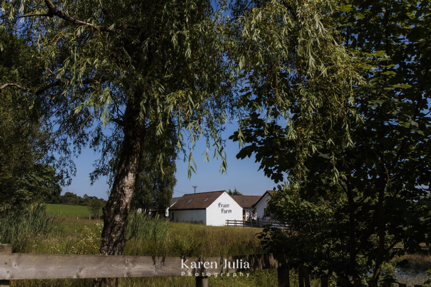 an exterior photo of Fruin Farm framed with trees