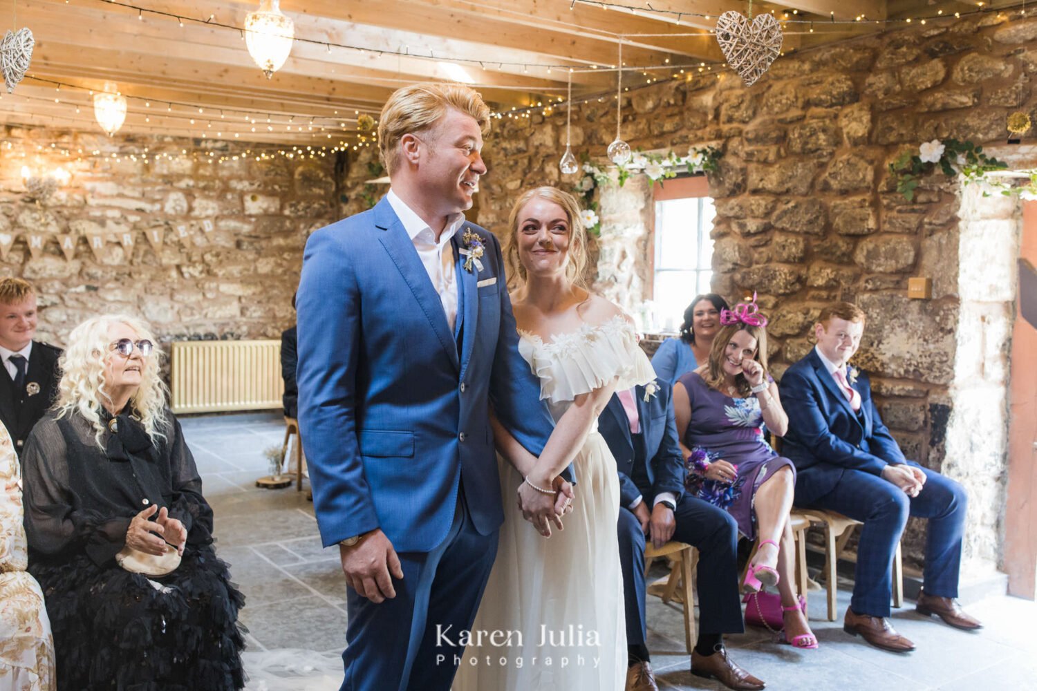 bride and groom hold hands during their wedding ceremony at Fruin Farm