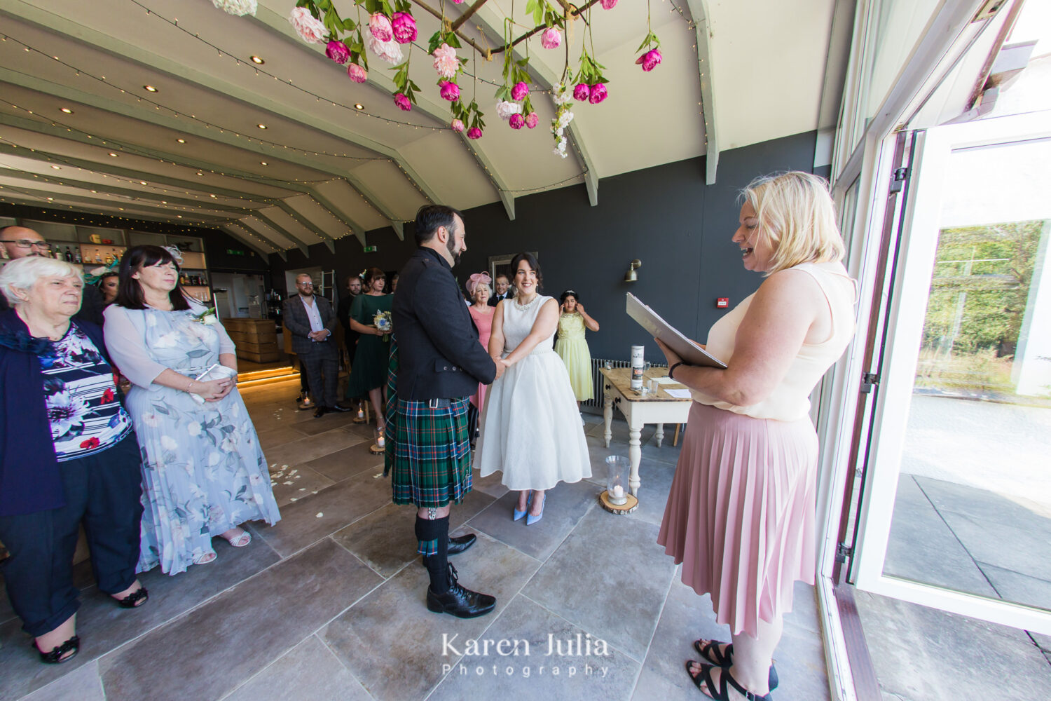 bride and groom exchange vows read by a humanist celebrant in the Farmhouse