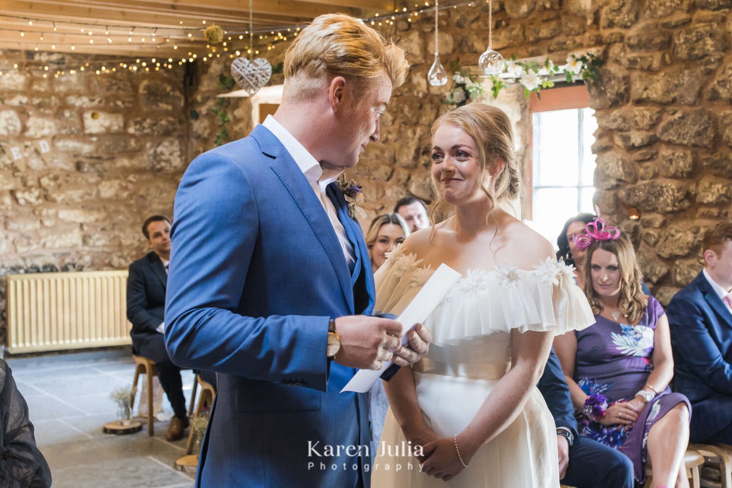 groom reads his vows to the bride during the wedding ceremony