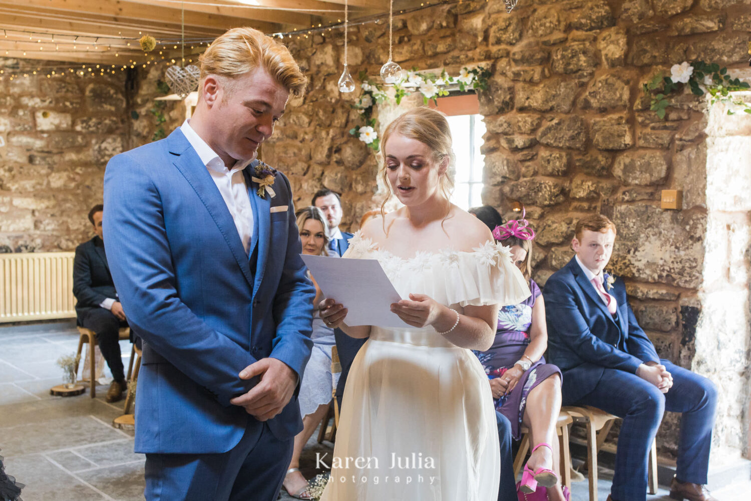 bride reads her vows to her groom during wedding ceremony