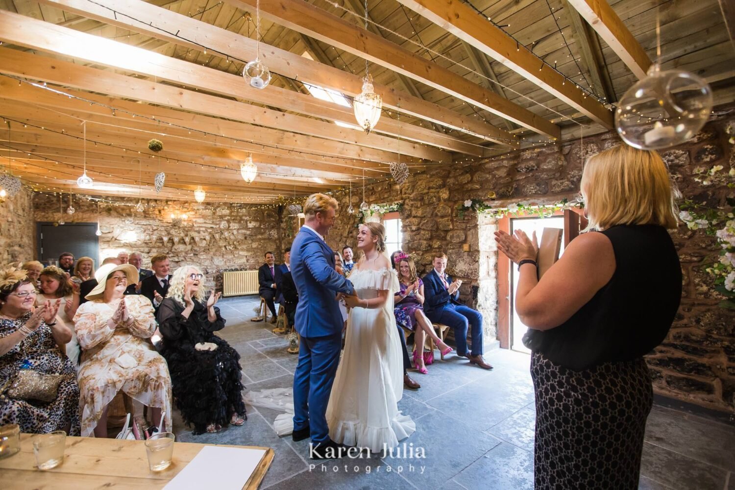 bride and groom look at each other as guests give them a round of applause