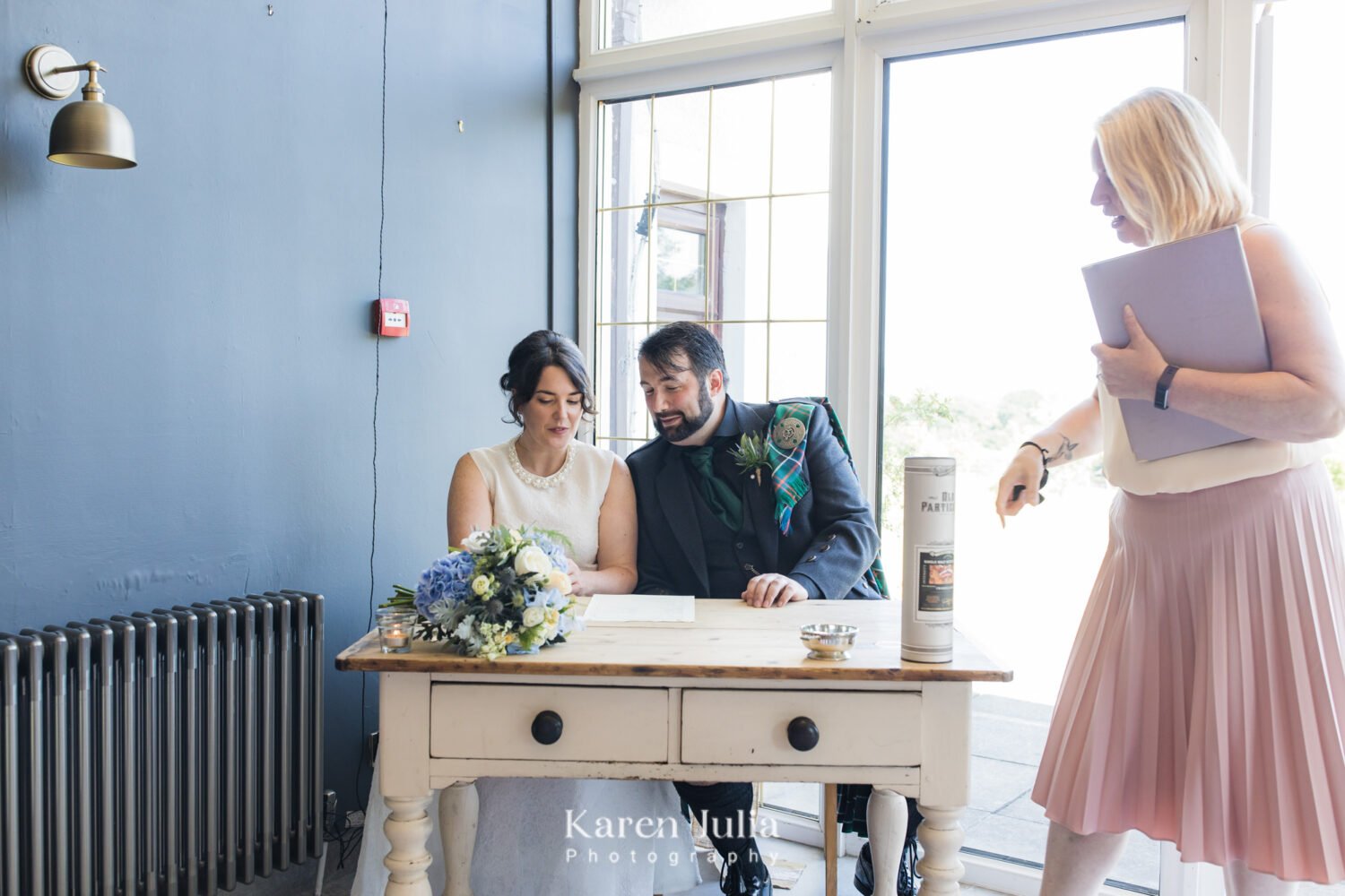 bride and groom sign the register in the Fruin Farm farmhouse