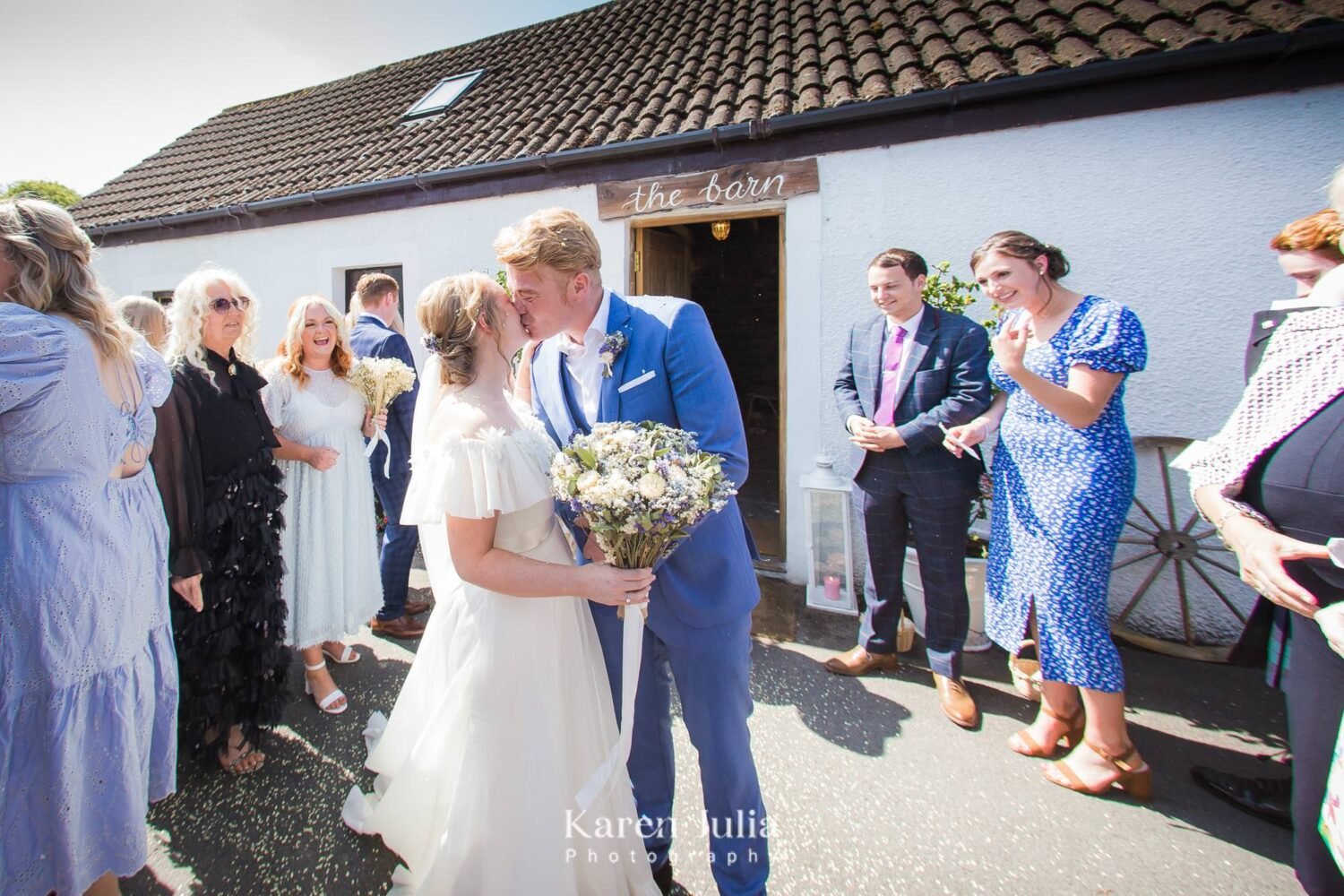 bride and groom kiss outside the barn at Fruin Farm