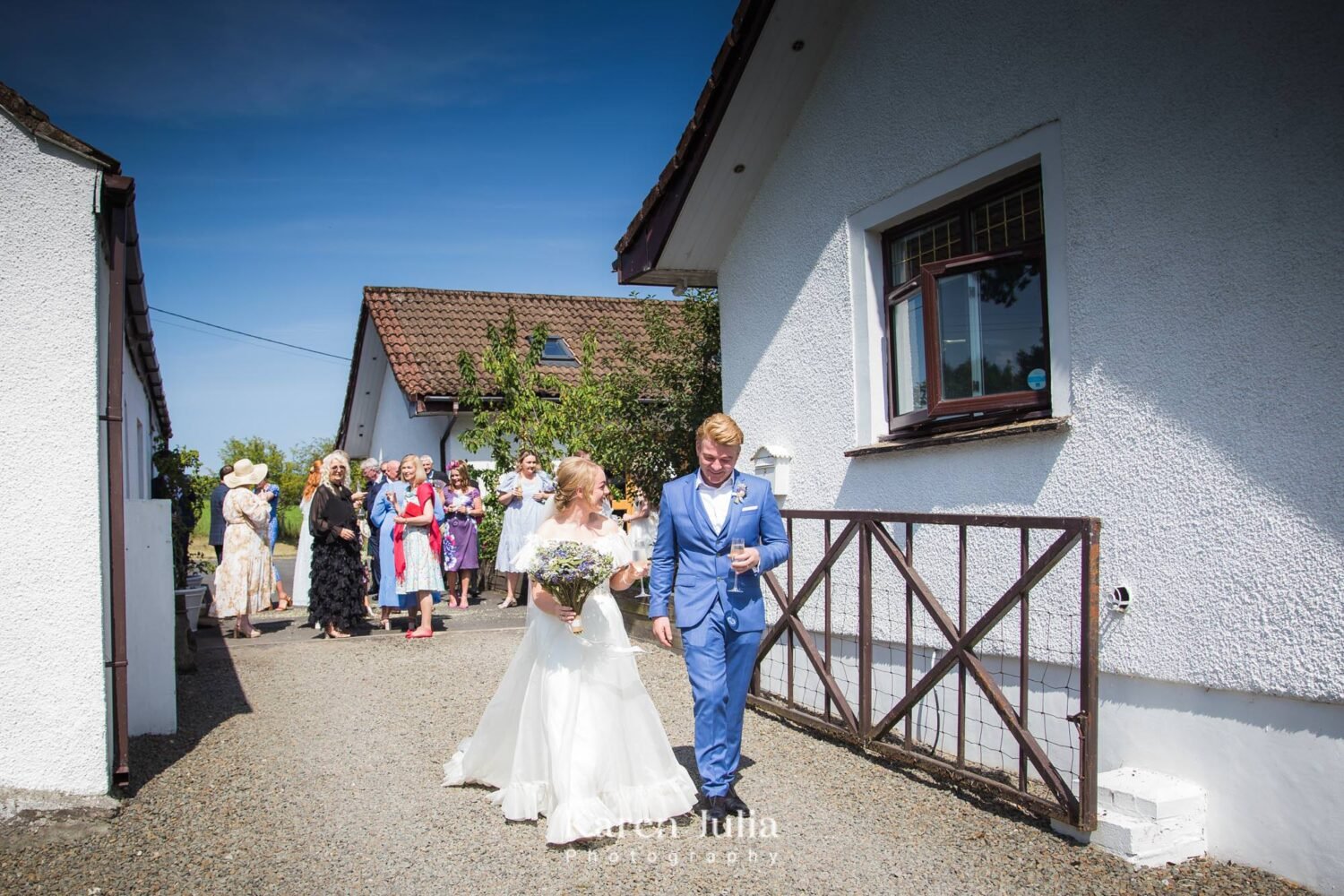 bride and groom walk towards the drinks reception area at Fruin Farm