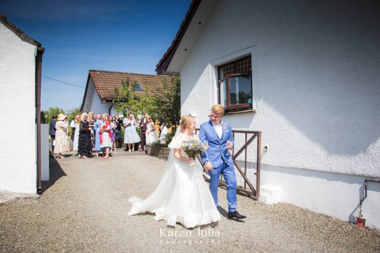 bride and groom walking together at Fruin Farm in Helensburgh