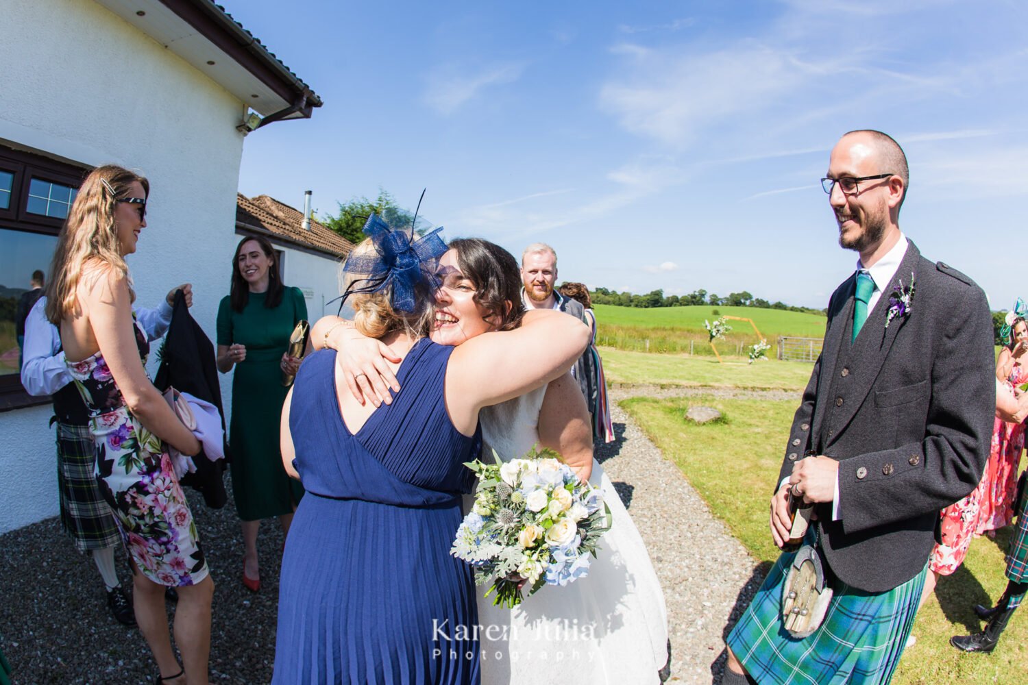 bride hugs guests during the drinks reception at Fruin Farm